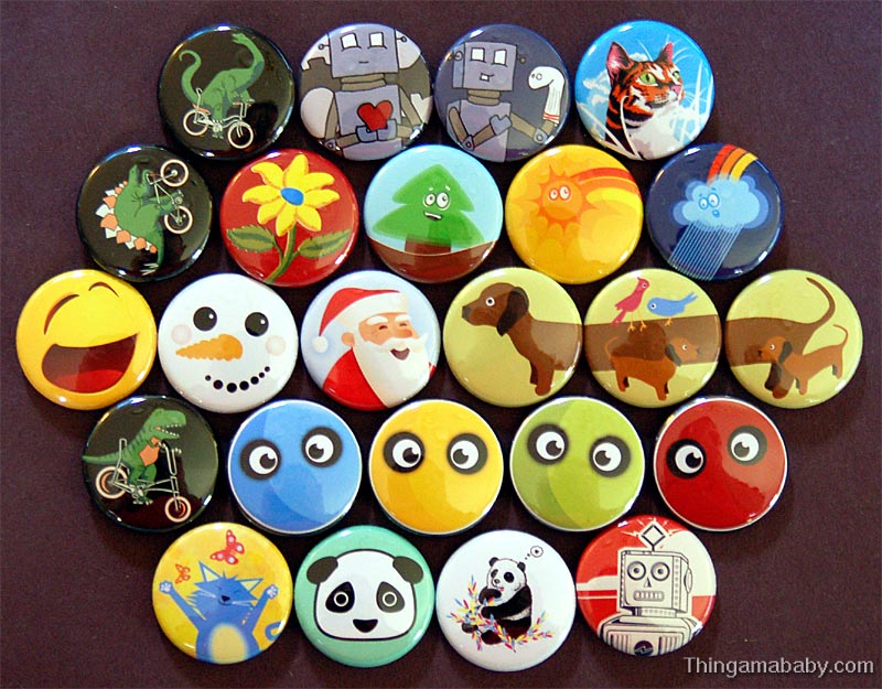 A variety of brightly-colored buttons showing cartoon animals, faces, robots, and plants are arranged in rows on a brown surface.