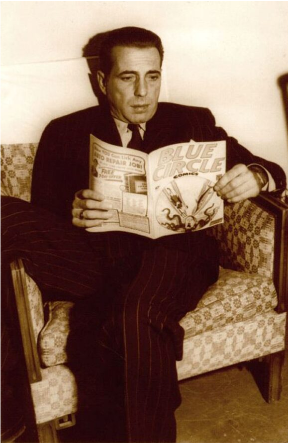 Vintage publicity photograph of actor, Humphrey Bogart reading a comic book.