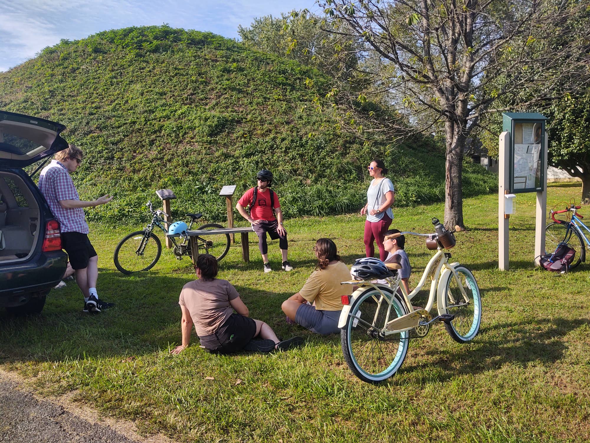 Bike Riders Resting By Mound