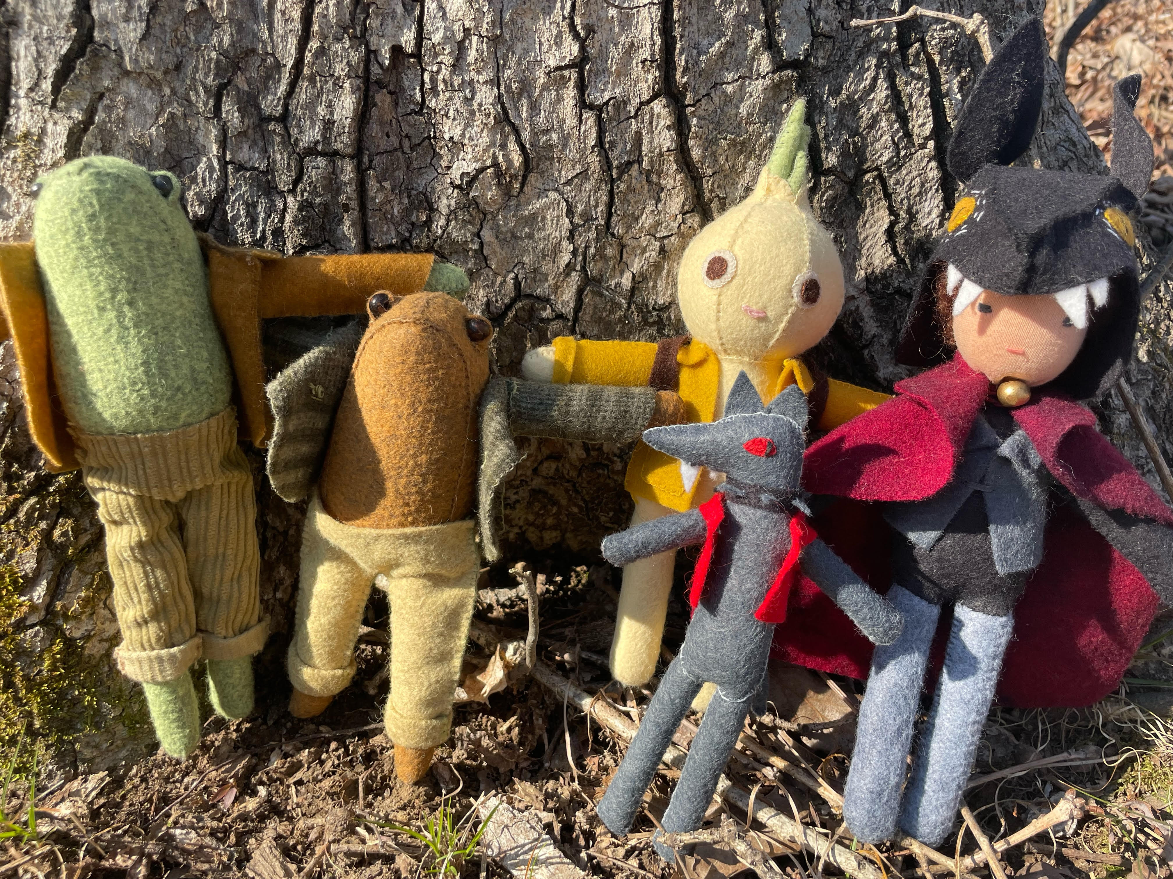 Handmade Dolls Leaning Against A Tree
