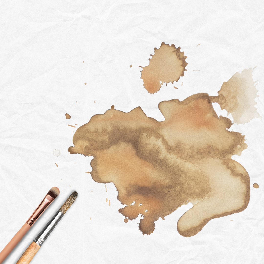 An image of a coffee stain and paint brushes on a crumpled piece of paper
