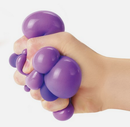 A hand squeezes a purple stress ball