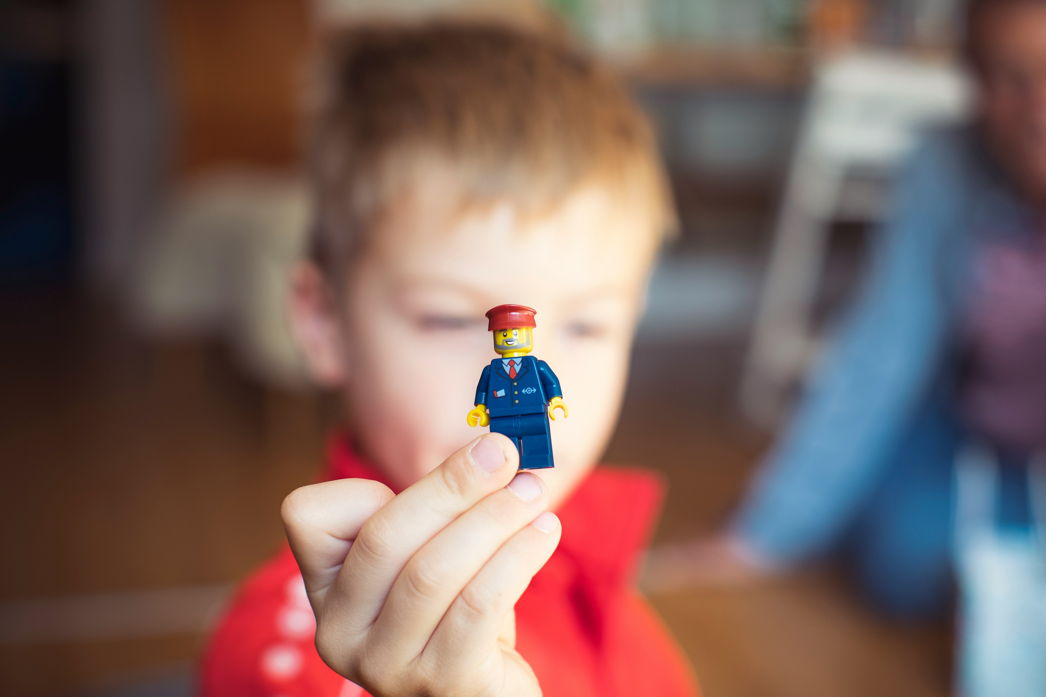 boy holding out lego person