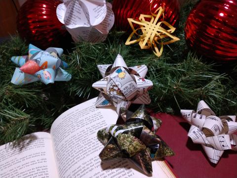A picture of gift bows and ornaments made from upcycled books