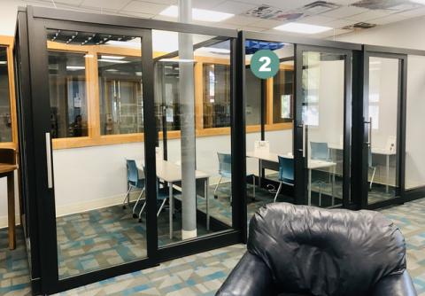 Photo showing three glass study cubicles with the first on the right labeled "2"