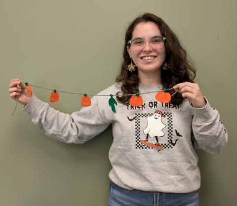 Human Holding Handmade Pumpkin Garland