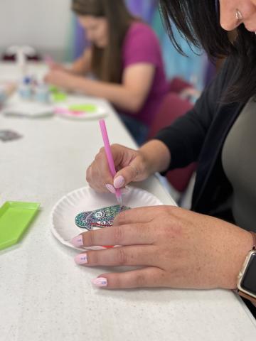 At the Coolville Public Library, ACPL Assistant Director Lindsay makes a diamond dot bird. Coolville librarian Deidra is seen crafting in the background. 