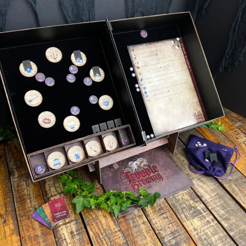 An open grimoire from the game Blood on the Clocktower on a wooden table