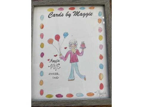 An illustration of aAn illustration of a woman holding balloons. Script above her reads, "Cards by Maggie"