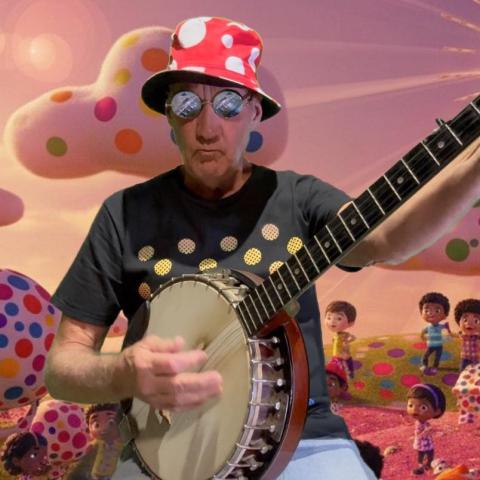 A man in a bucket hat and sunglasses plays the banjo against a colorful background