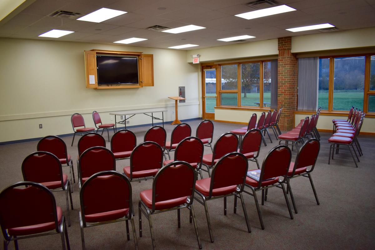 Large meeting room in the Athens Public Library, including rows of chairs.