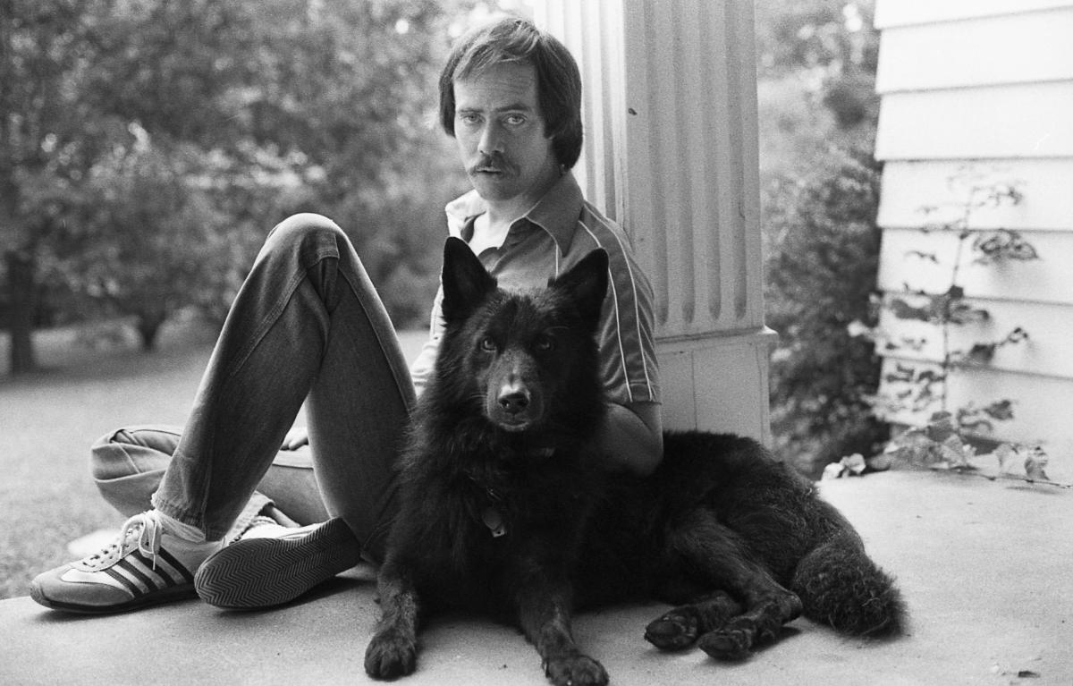 Image of honored photographer Brian Blauser, and his canine companion.