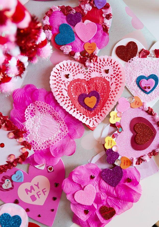 Several homemade, mostly pink Valentines cards on a white background.