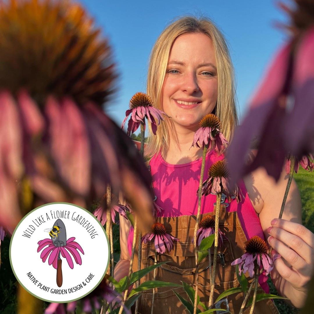 Women in Pink Shirt Behind Flowers