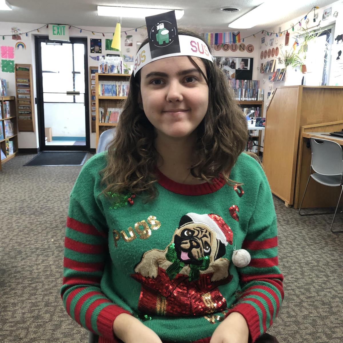 A teen wears a headband featuring a "roommate" from Among Us.