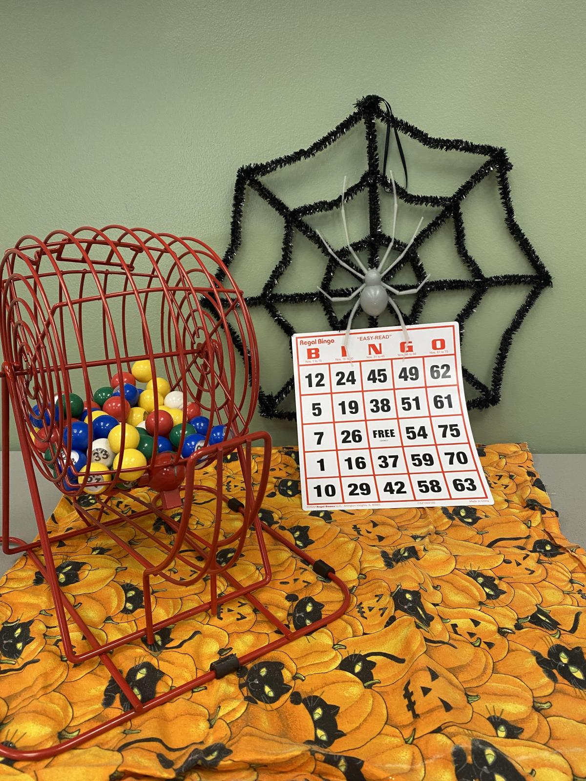 Bingo Card in Front of Spider Web Wreath on Halloween Fabric