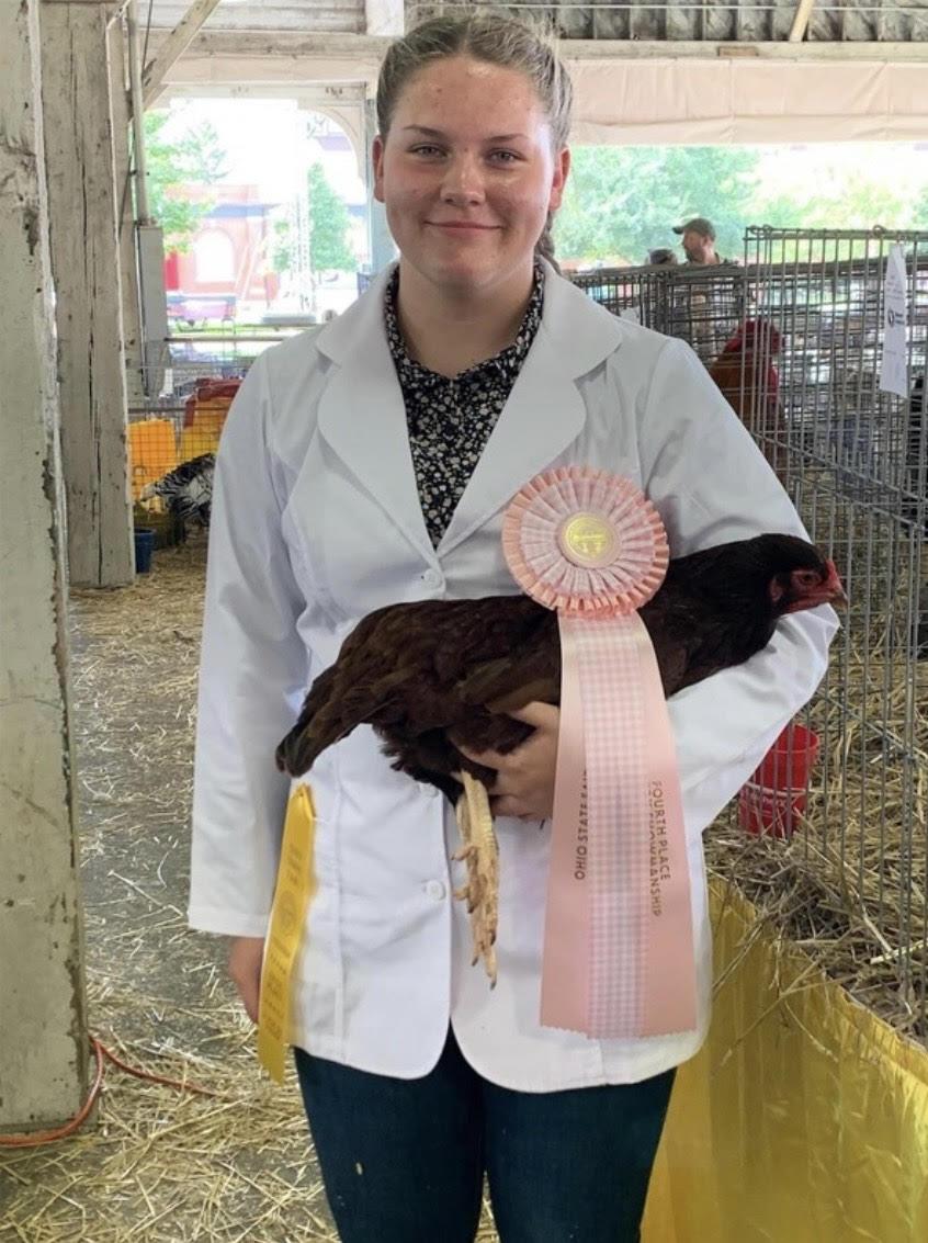 Human Holding Chickin with a Ribbon on it