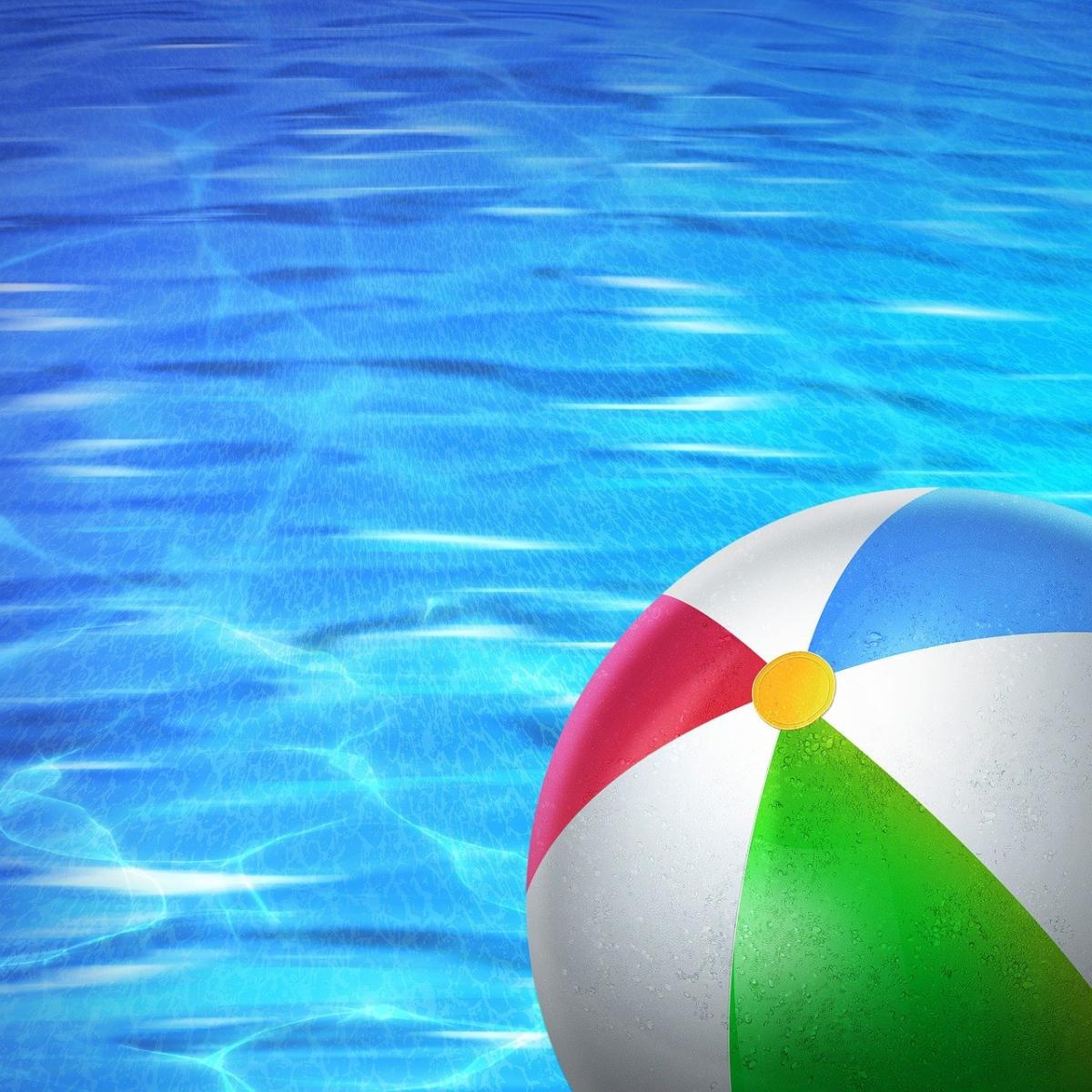 A colorful beach ball against a background of swimming pool water
